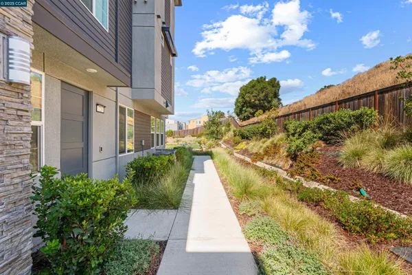 a view of a swimming pool with a patio and garden