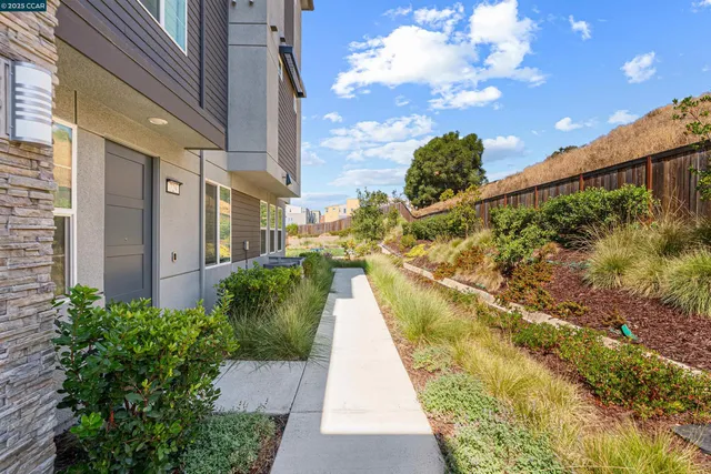 a view of a swimming pool with a patio and garden