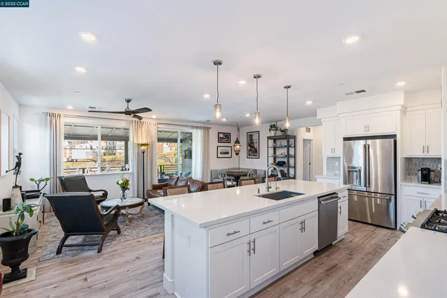 a kitchen with stainless steel appliances a sink stove and refrigerator