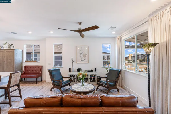 a dining room with furniture a window and a chandelier