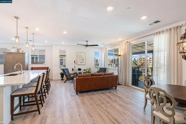 a living room with furniture or wooden floor and a large window
