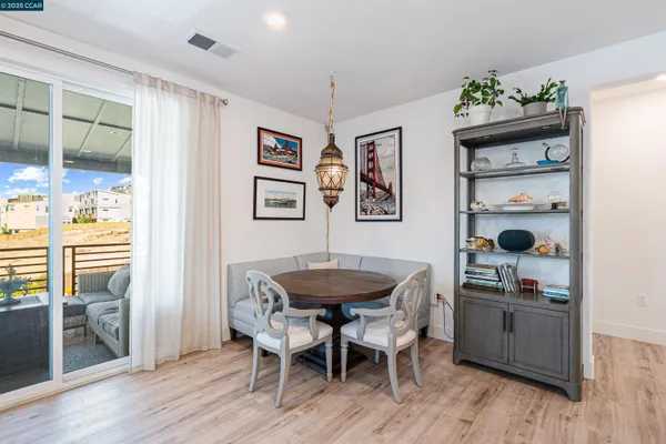a dining room with furniture and wooden floor