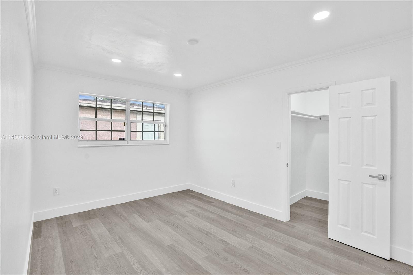 7813 Granada Boulevard Miramar, FL 33023 - Photo 20 of 35 an empty room with wooden floor and windows