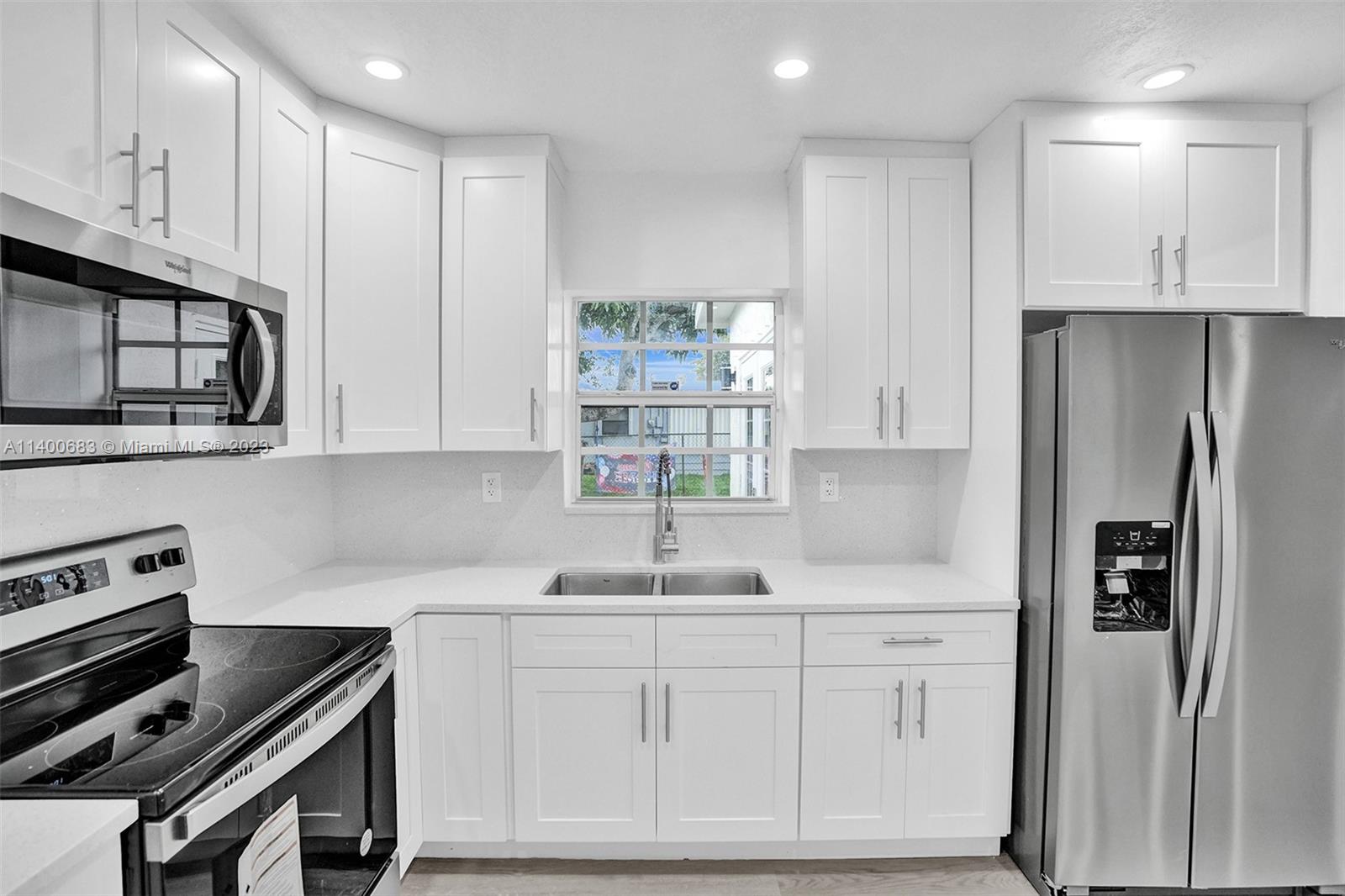 7813 Granada Boulevard Miramar, FL 33023 - Photo 2 of 35 a kitchen with stainless steel appliances cabinets and a window