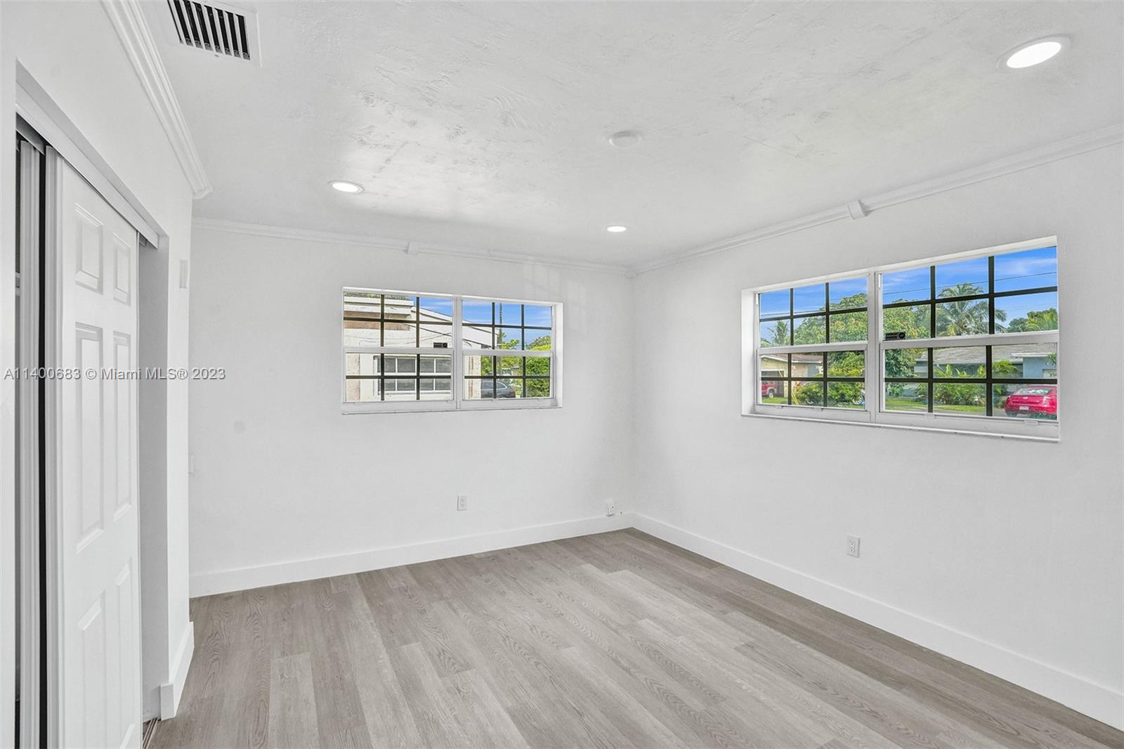 7813 Granada Boulevard Miramar, FL 33023 - Photo 24 of 35 an empty room with wooden floor and windows