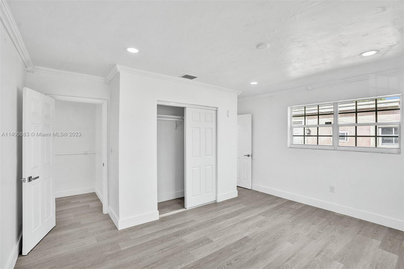 7813 Granada Boulevard Miramar, FL 33023 - Photo 25 of 35 an empty room with wooden floor and windows