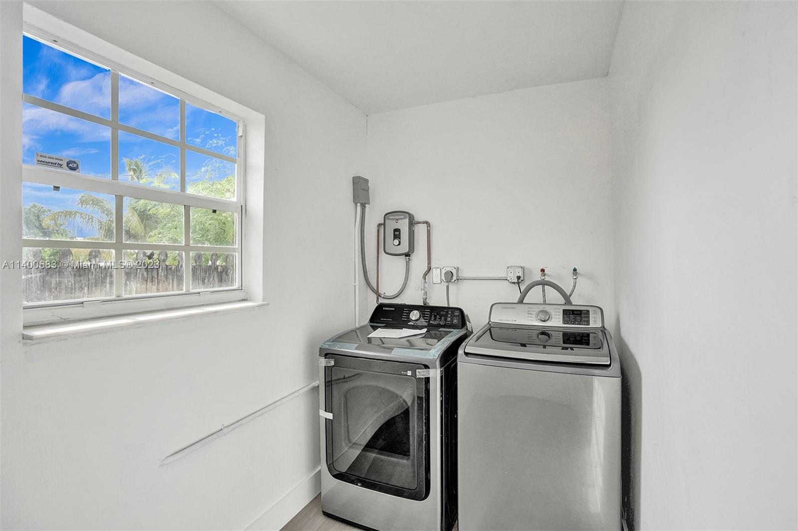 7813 Granada Boulevard Miramar, FL 33023 - Photo 29 of 35 a utility room with dryer and washer