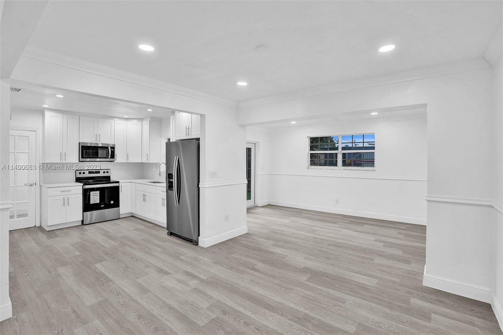 7813 Granada Boulevard Miramar, FL 33023 - Photo 3 of 35 a kitchen with stainless steel appliances a refrigerator and a stove top oven