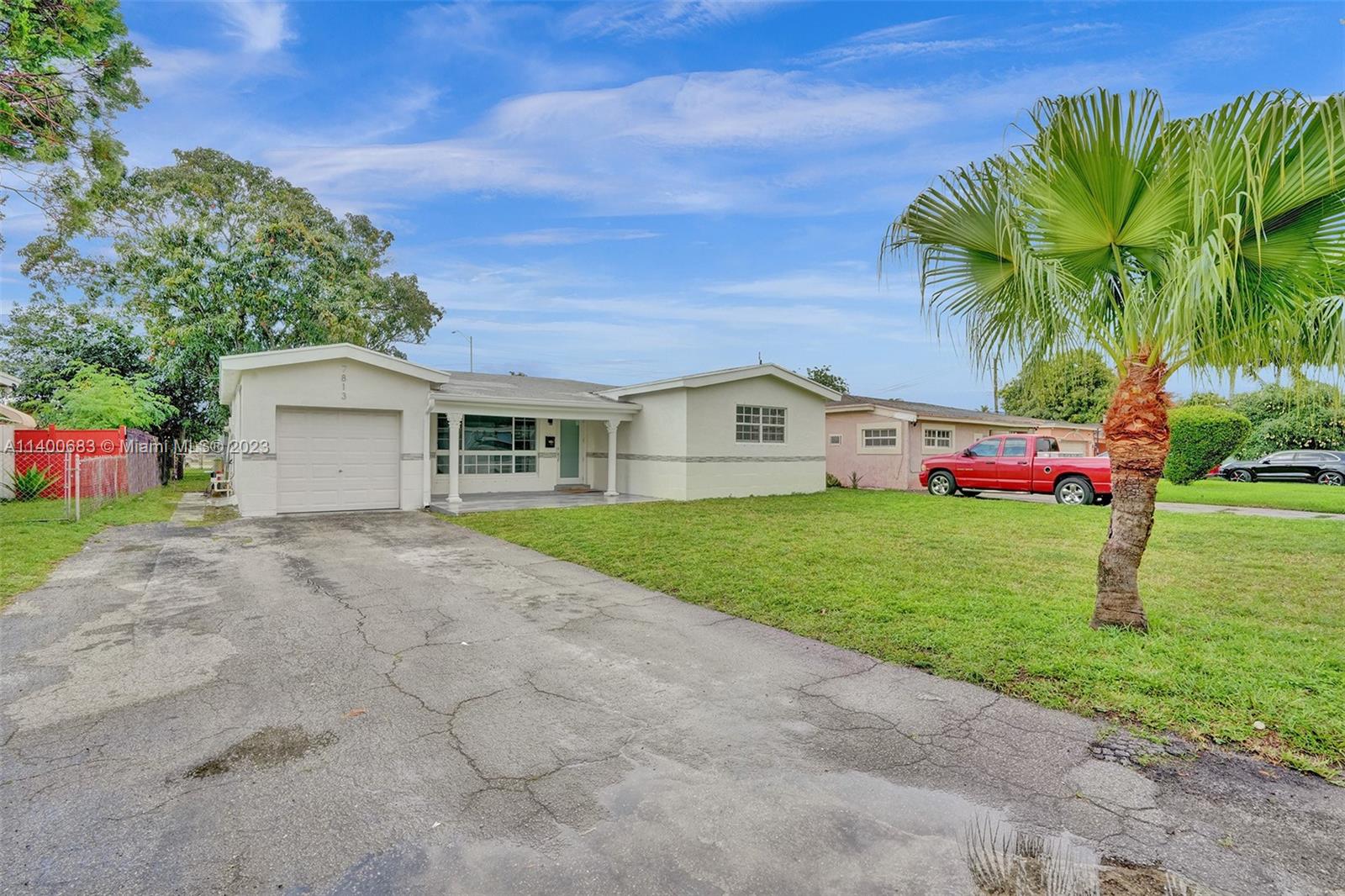 7813 Granada Boulevard Miramar, FL 33023 - Photo 34 of 35 a front view of house with yard and green space