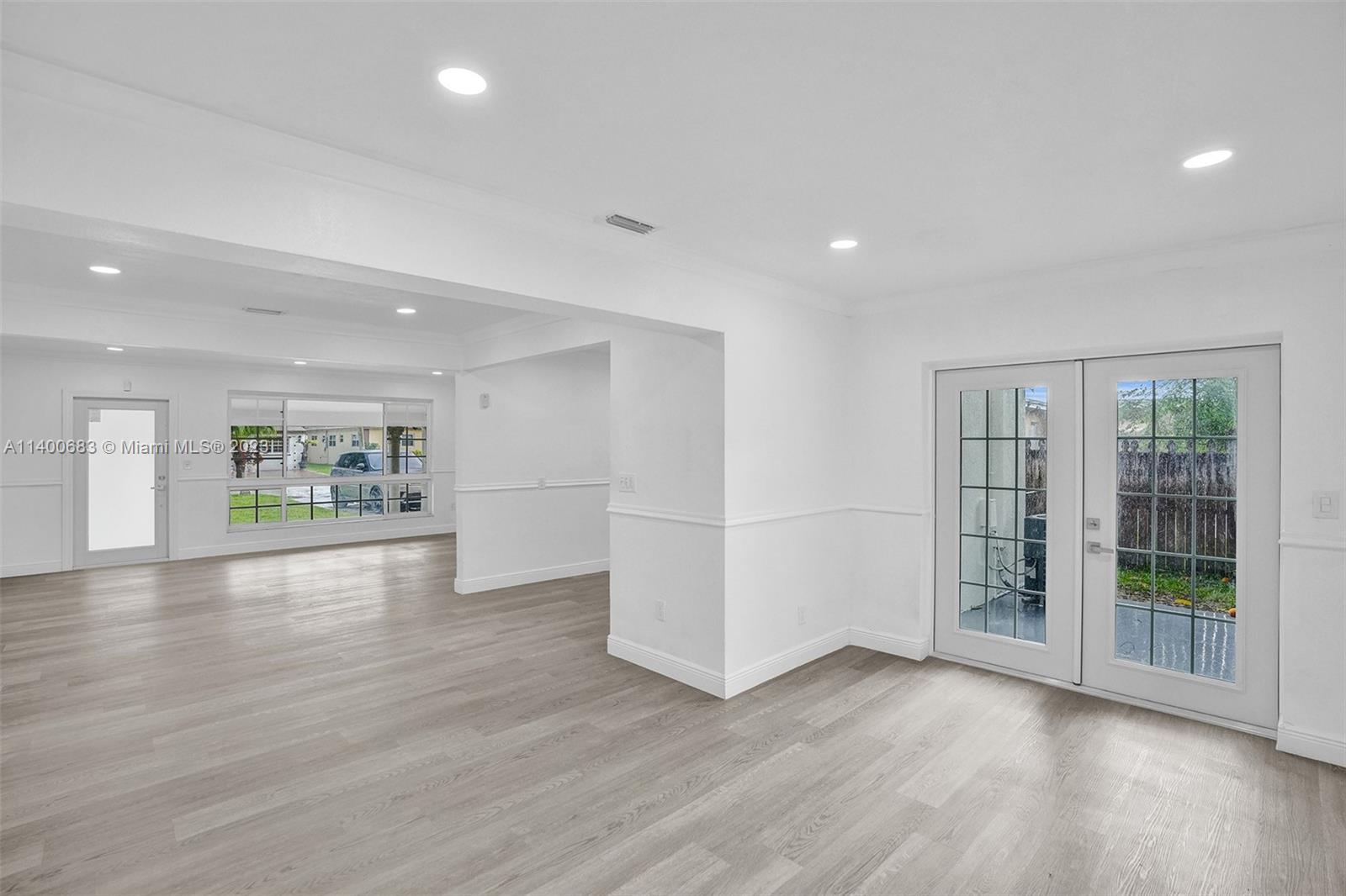 7813 Granada Boulevard Miramar, FL 33023 - Photo 5 of 35 a view of an empty room with wooden floor and a window