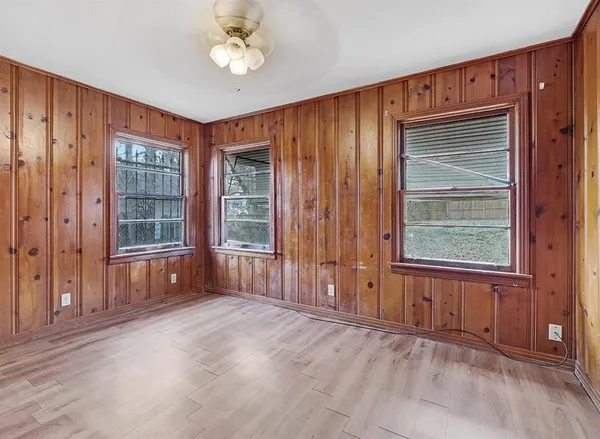 an empty room with windows and closet