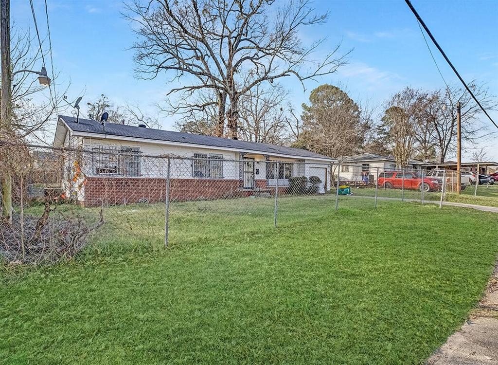 1121 Wheeler Street Texarkana, TX 75503 - Photo 3 of 14 a view of a house with a backyard and a tree