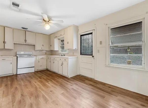a view of kitchen with wooden floor and window