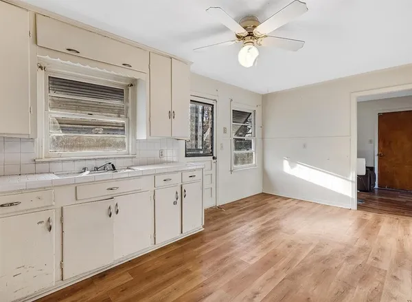 a kitchen with granite countertop a sink stainless steel appliances and cabinets