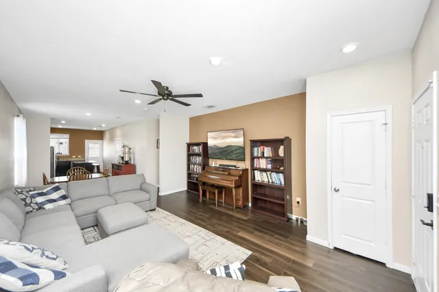 a living room with furniture and wooden floor