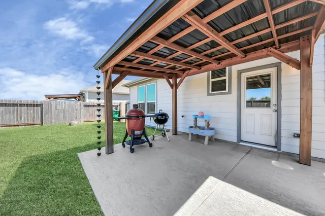 a view of a porch with a table and chairs