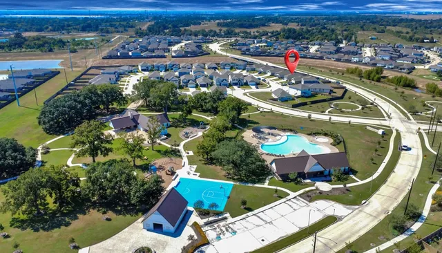 an aerial view of a house a yard and outdoor seating