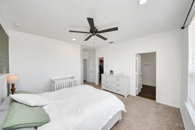 a bedroom with a bed and cabinets