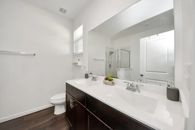a bathroom with a sink a toilet and a mirror