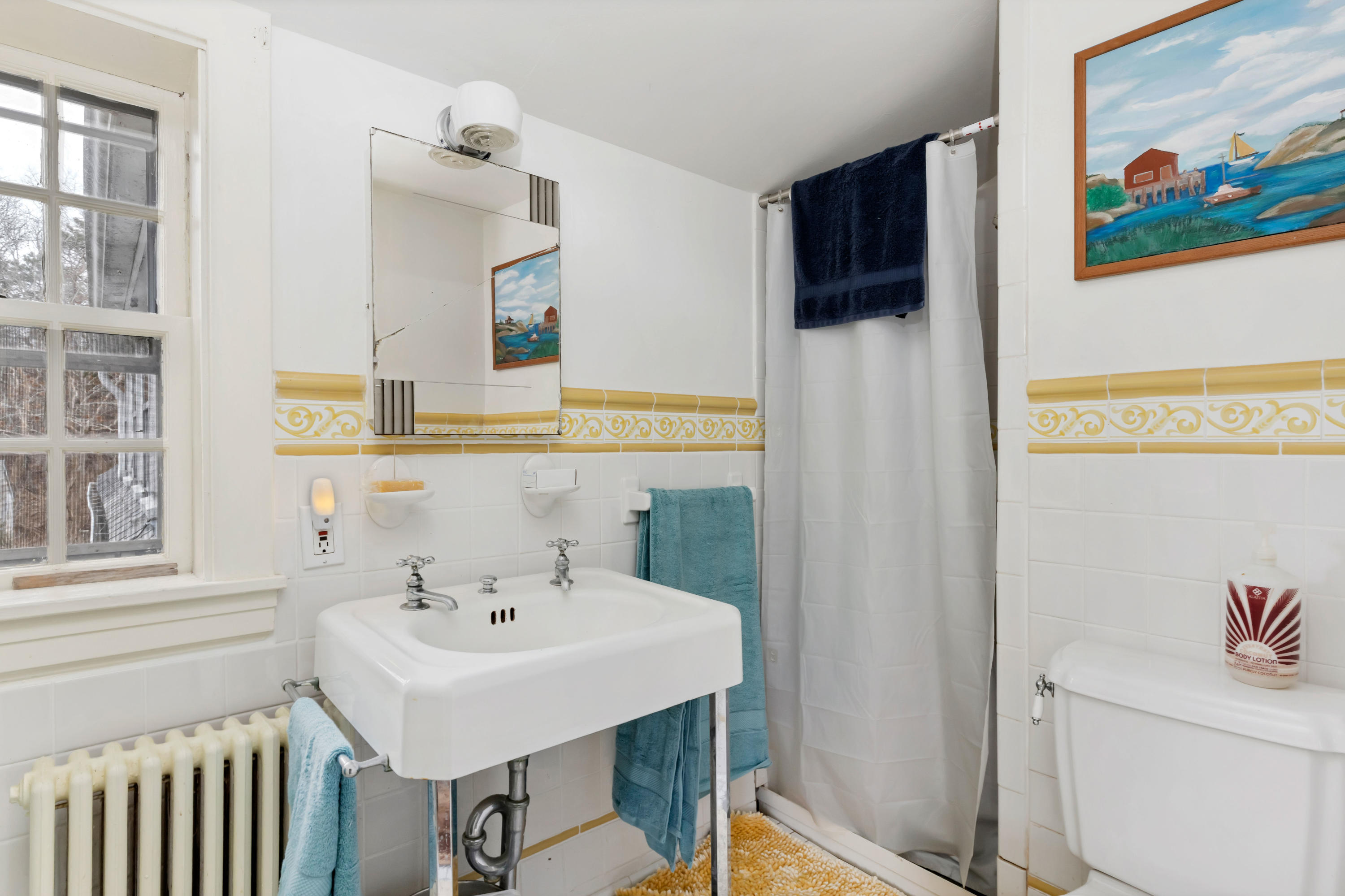 3 Hughes Road Truro, MA 02666 - Photo 15 of 34 a bathroom with a sink a toilet and a mirror