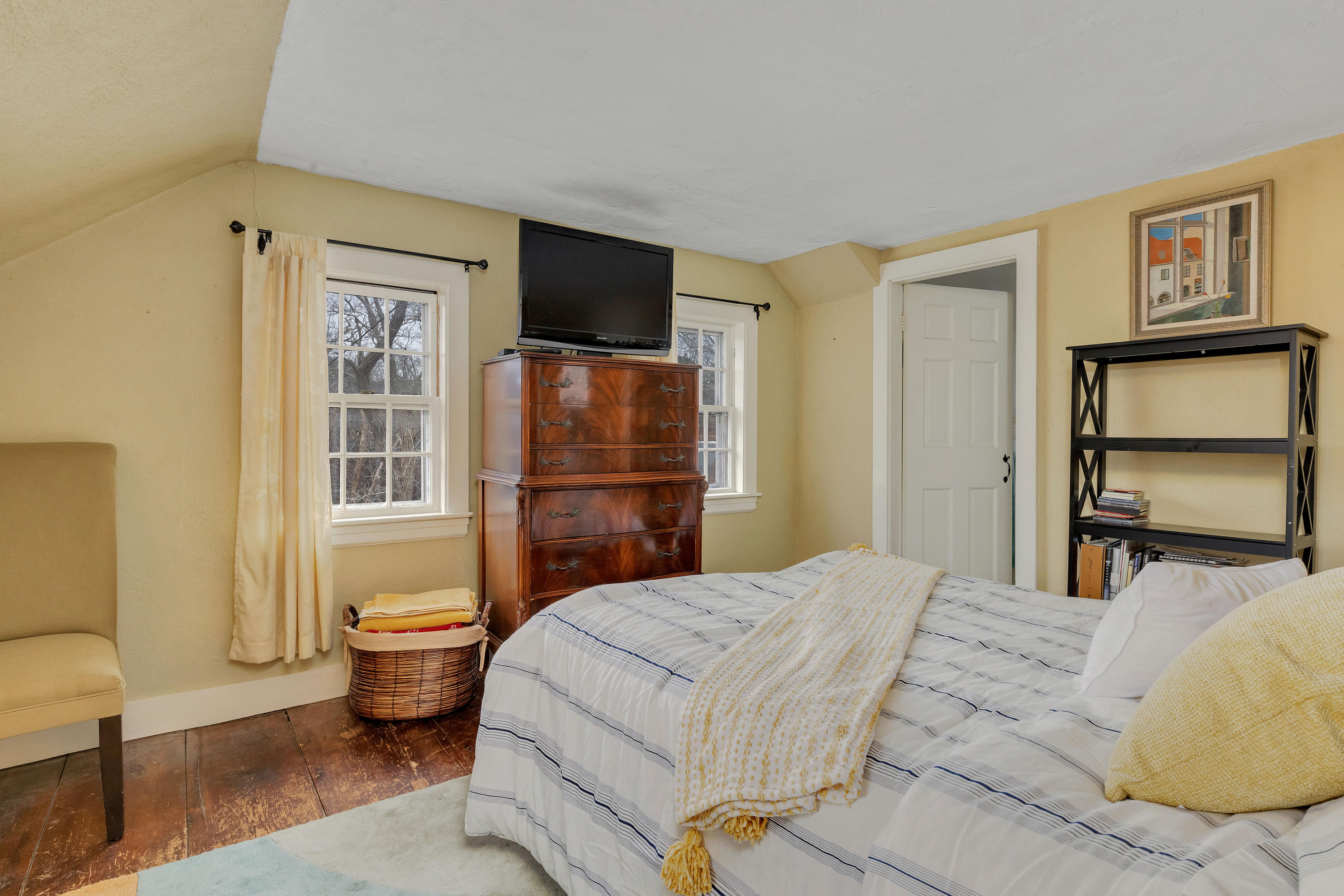 3 Hughes Road Truro, MA 02666 - Photo 16 of 34 a bedroom with a bed and wooden floor