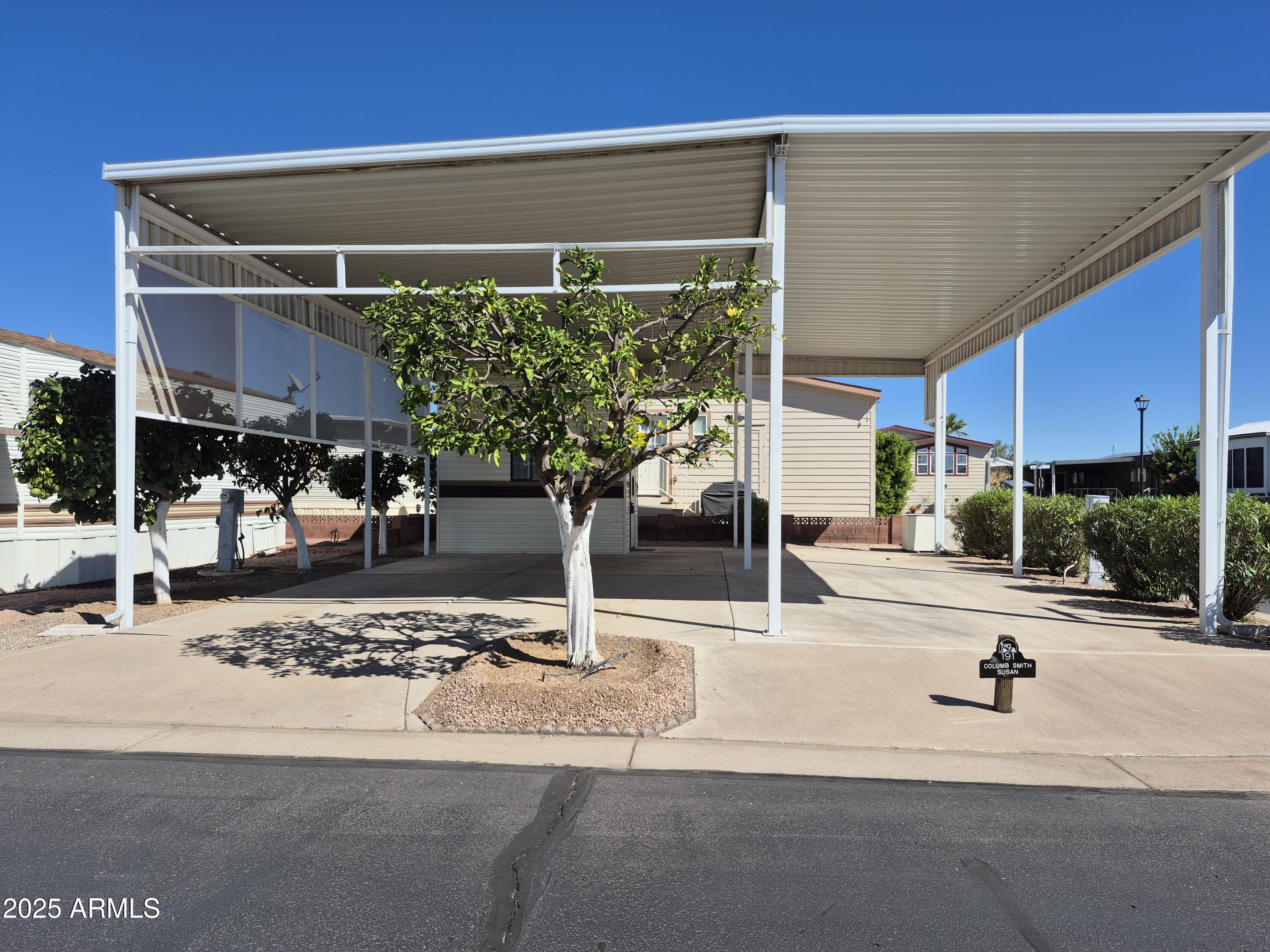 7750 East Broadway Road, Unit 191 Mesa, AZ 85208 - Photo 3 of 23 a view of a patio with a table and chairs