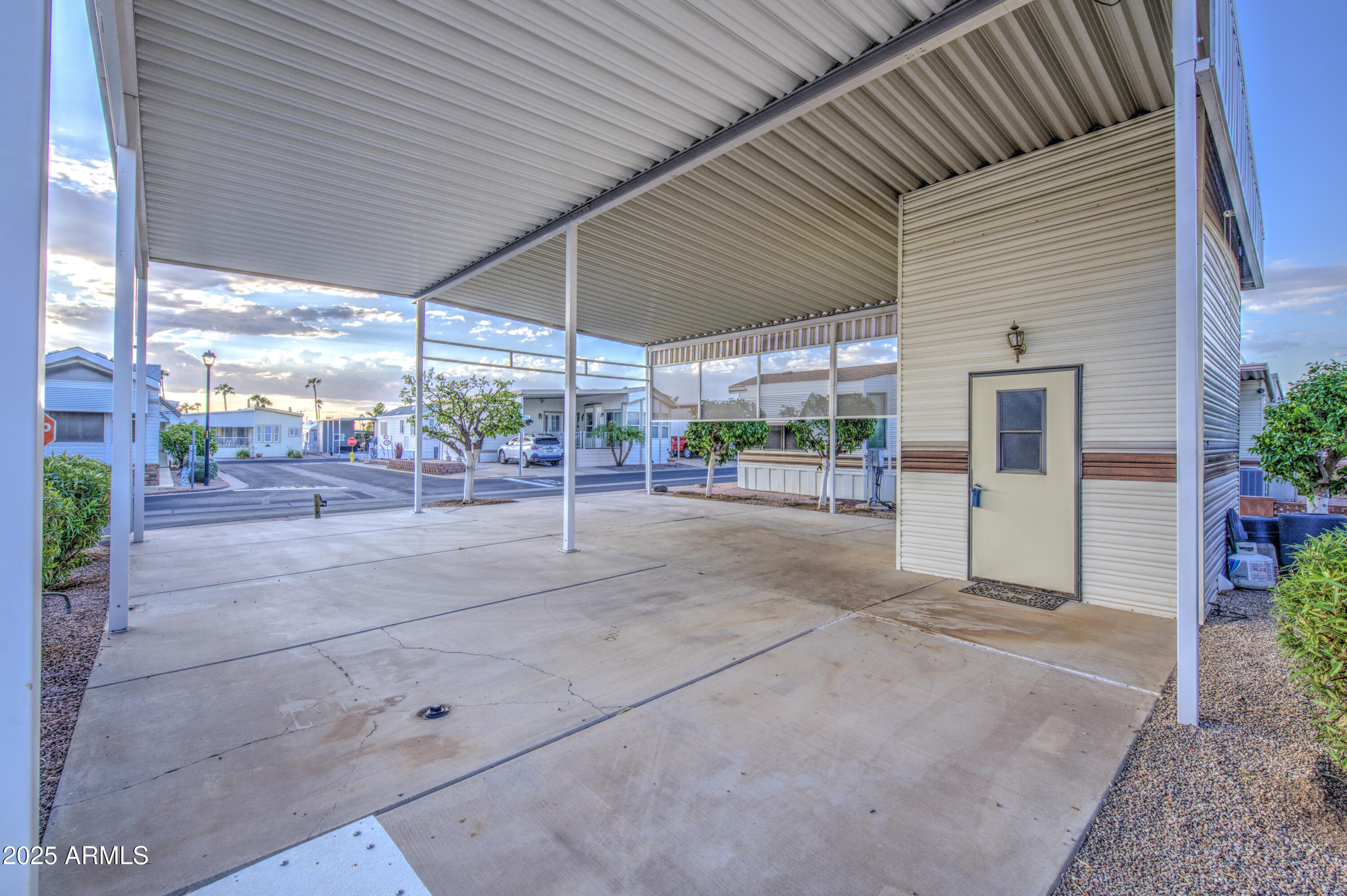 7750 East Broadway Road, Unit 191 Mesa, AZ 85208 - Photo 4 of 23 a view of a patio with a table and chairs under an umbrella