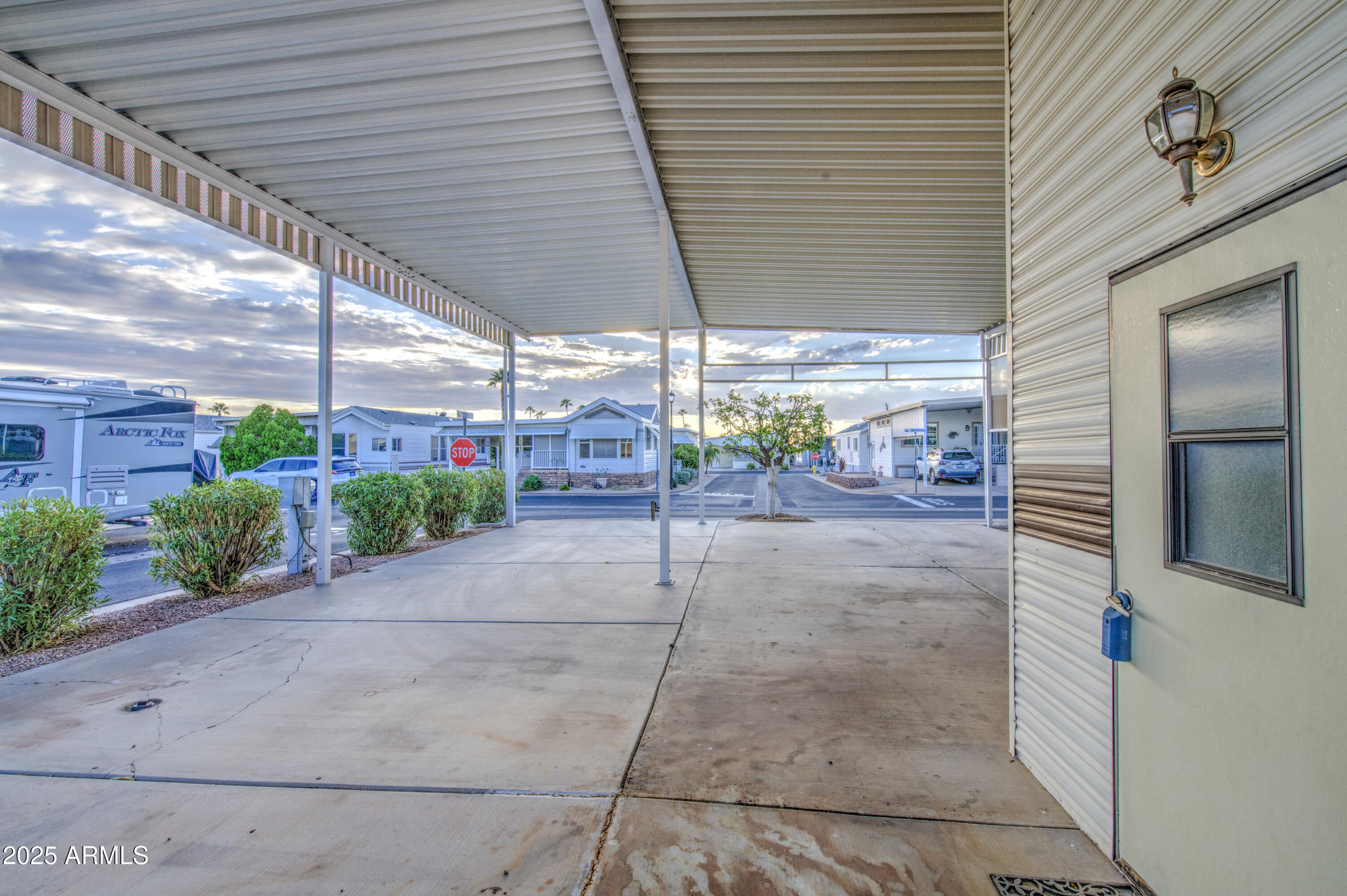 7750 East Broadway Road, Unit 191 Mesa, AZ 85208 - Photo 5 of 23 a view of a garage with a table and chairs and potted plants