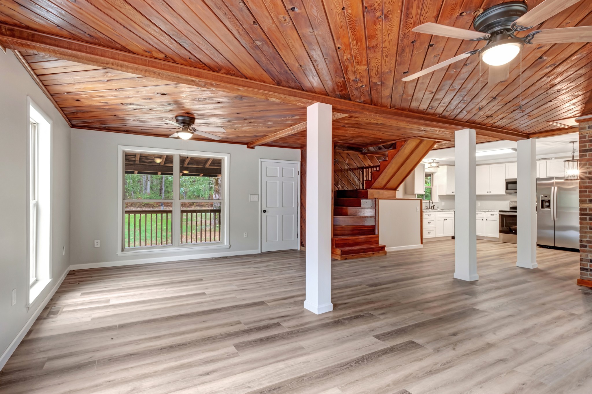 2312 Little Fish Trap Road Lawrenceburg, TN 38464 - Photo 19 of 48 a view of an empty room with wooden floor and a ceiling fan