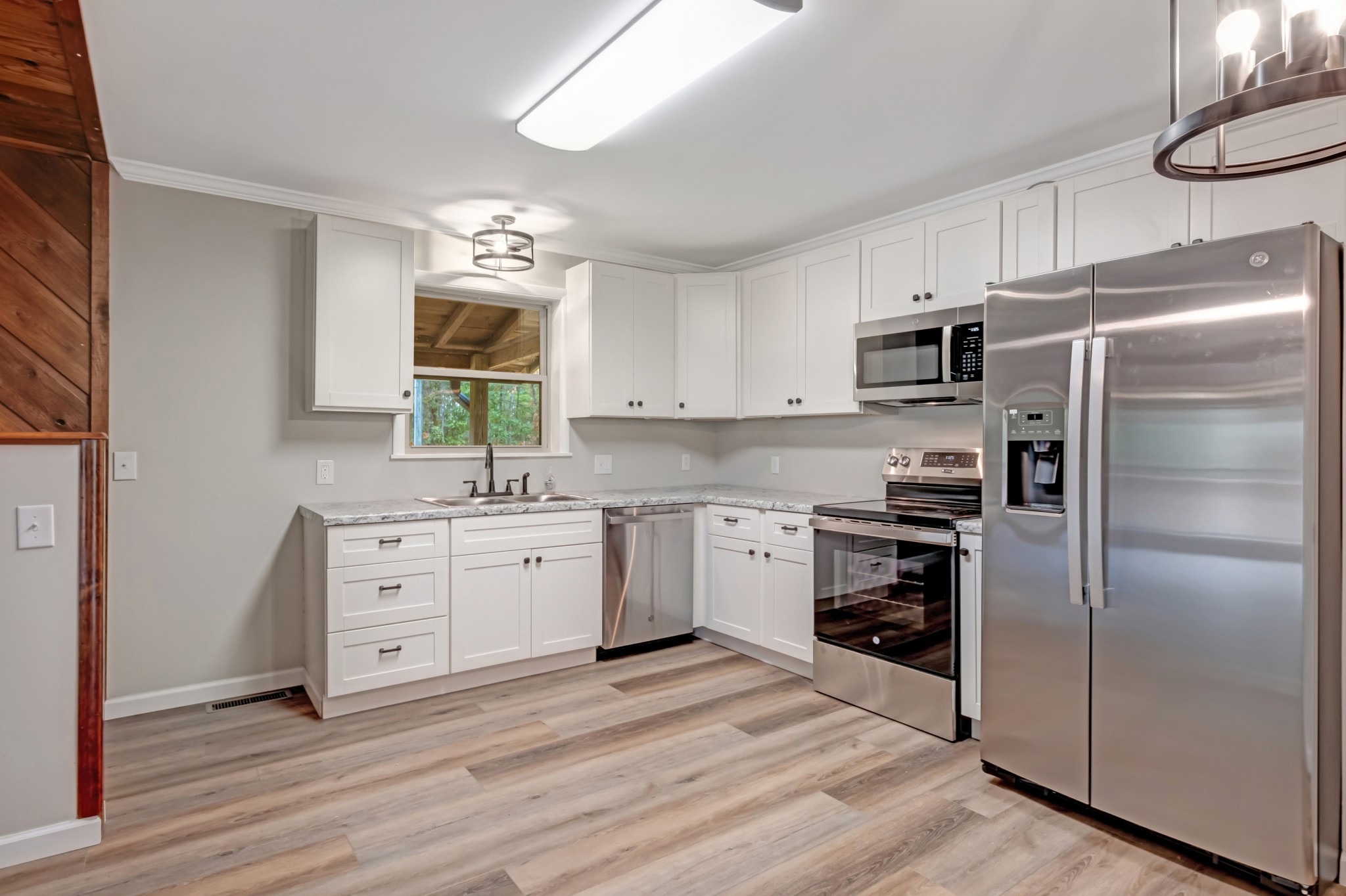 2312 Little Fish Trap Road Lawrenceburg, TN 38464 - Photo 23 of 48 a kitchen with white cabinets stainless steel appliances and a window