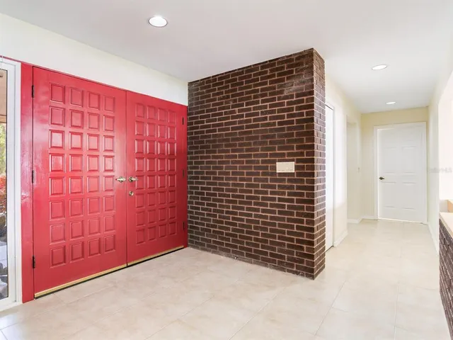 a large kitchen with granite countertop a large counter top and stainless steel appliances