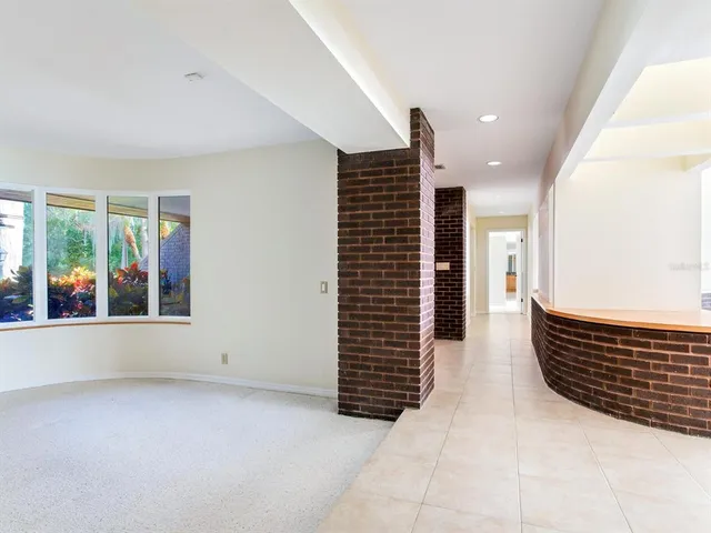 a bathroom with a granite countertop sink a toilet a mirror and shower