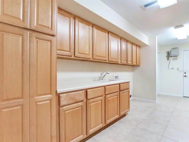 a view of house with swimming pool and sitting area