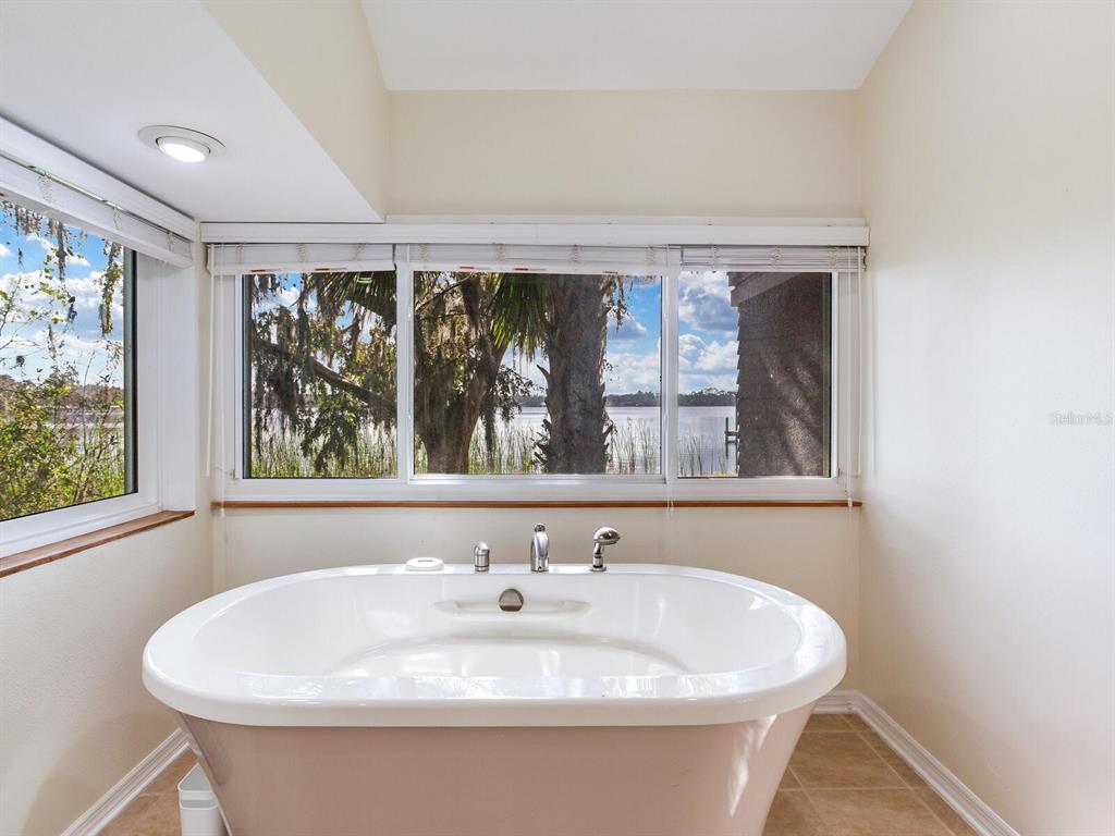 18120 Wayne Road Odessa, FL 33556 - Photo 62 of 100 a white bath tub sitting in a bathroom next to a window