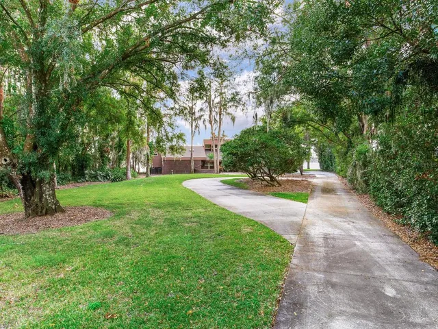 a dining hall with stainless steel appliances kitchen island a stove a kitchen island a dining table and chairs with wooden floor