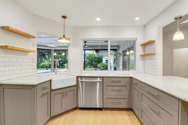 a kitchen with a sink window and cabinets