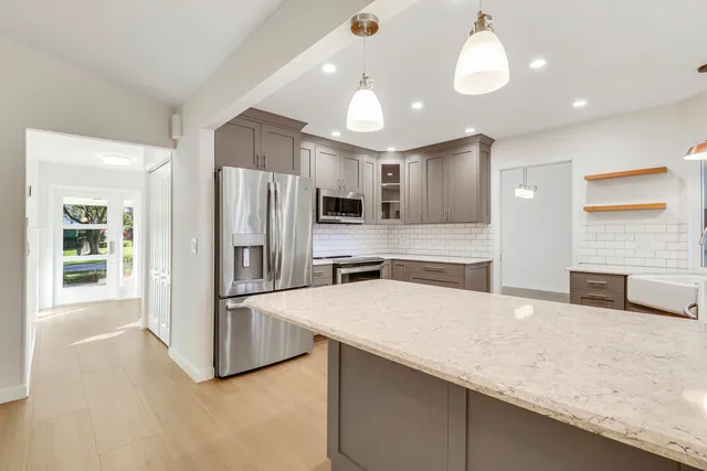 a view of a kitchen with a sink and a window