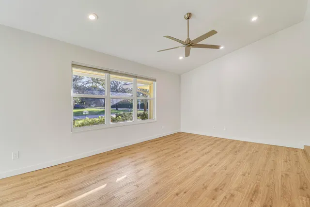 a view of a big room with wooden floor and a bathroom