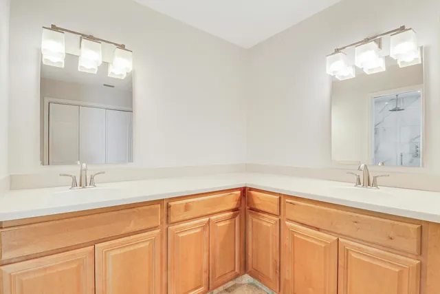 a spacious bathroom with a sink and mirror