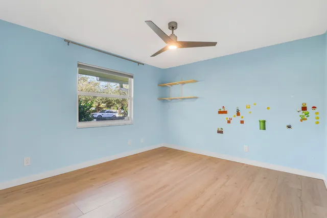 a bathroom with a granite countertop sink toilet and mirror