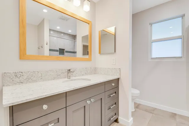 a bathroom with a shower and a mirror