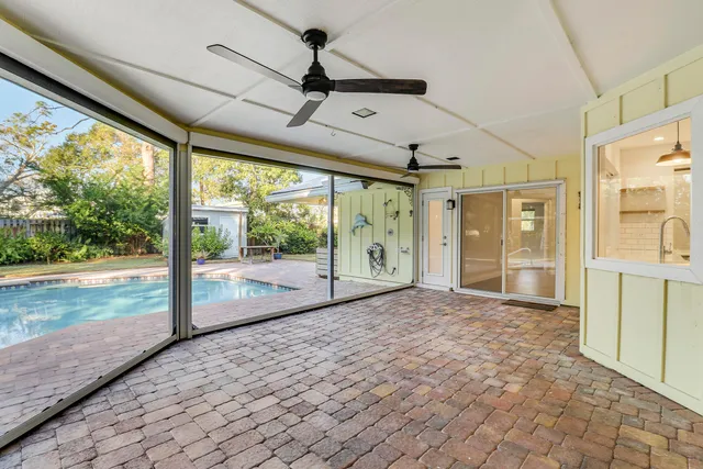 a view of a house with swimming pool and sitting area