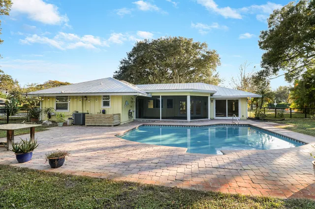 a view of a house with swimming pool and a yard