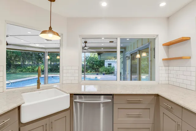 a kitchen with a sink and large window