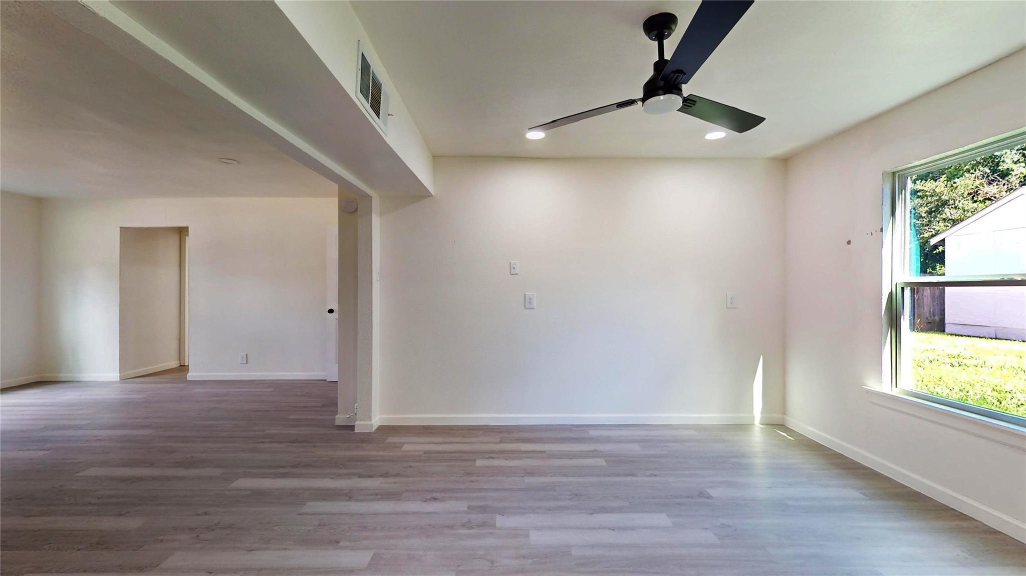 3806 Cosby Street Houston, TX 77021 - Photo 14 of 48 a view of an empty room with window and wooden floor