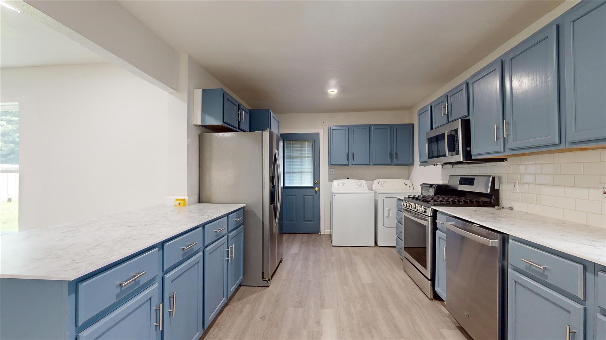 3806 Cosby Street Houston, TX 77021 - Photo 15 of 48 a kitchen with stainless steel appliances granite countertop a refrigerator a stove top oven a sink dishwasher and wooden cabinets