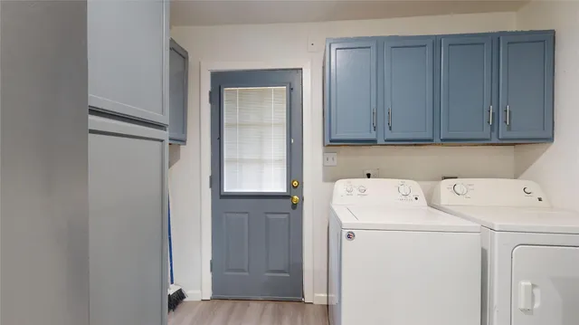 a view of storage and utility room with washer and dryer