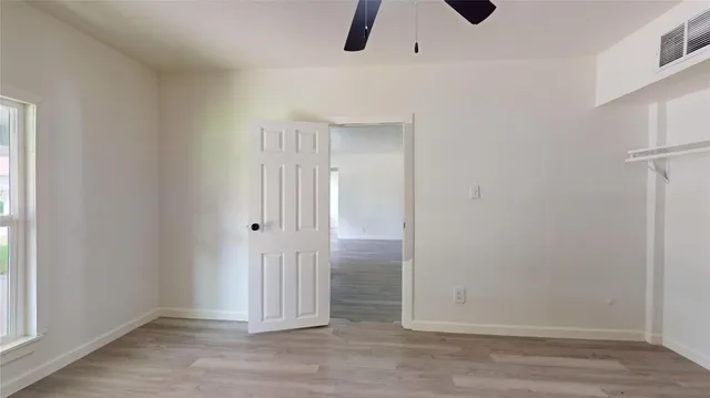 an empty room with wooden floor