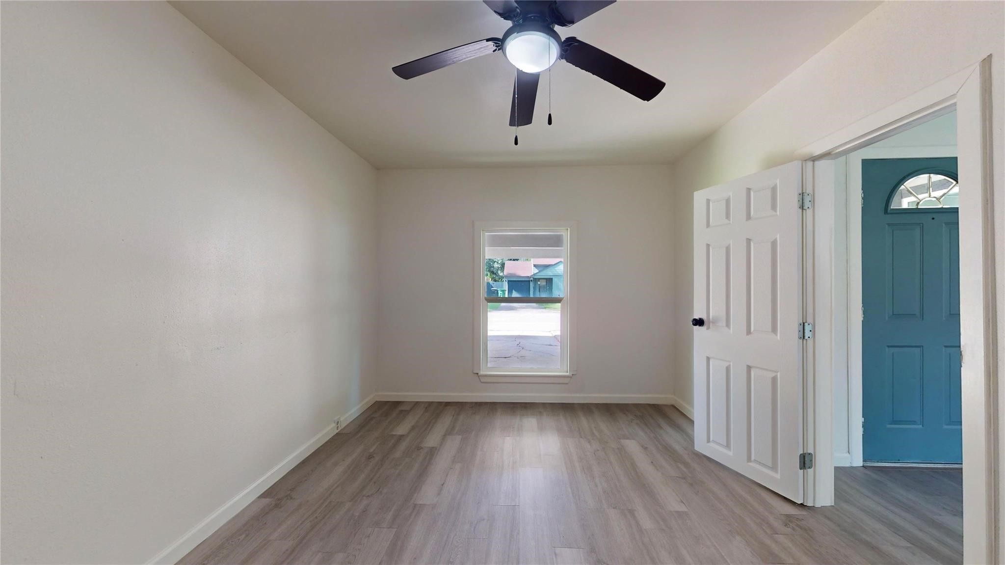 3806 Cosby Street Houston, TX 77021 - Photo 21 of 48 an empty room with wooden floor chandelier fan and windows