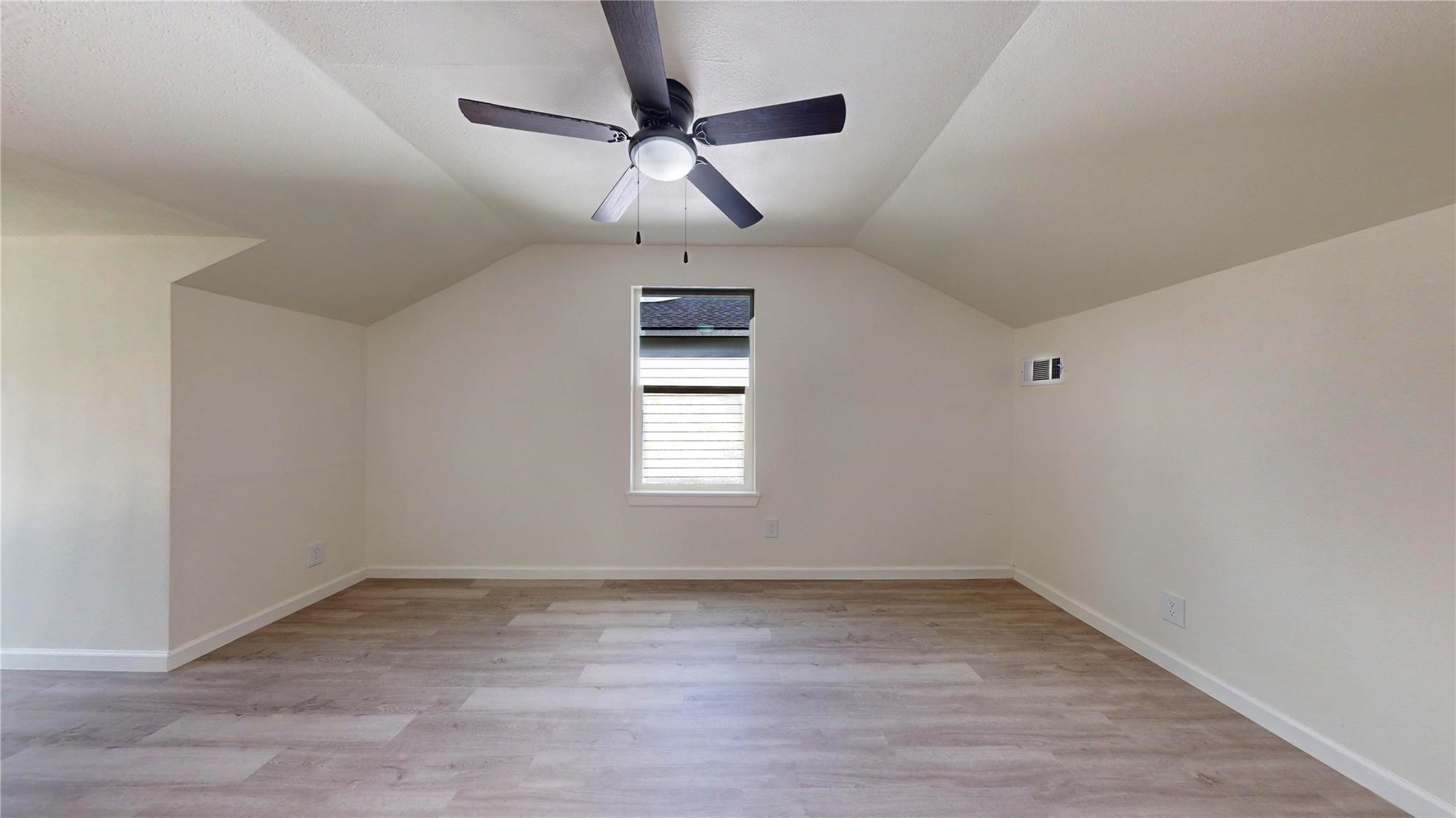 3806 Cosby Street Houston, TX 77021 - Photo 29 of 48 an empty room with wooden floor ceiling fan and window